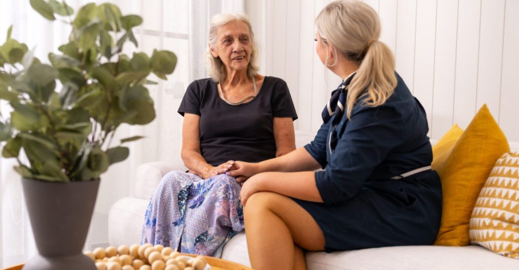 Support worker comforting elderly lady