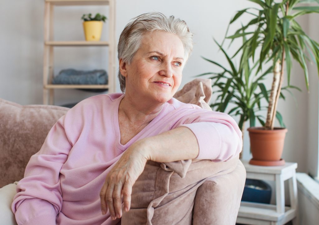 elderly lady looking out to the window